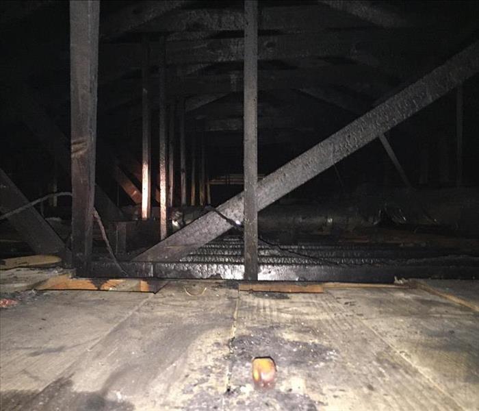 Attic with fire damaged beams.