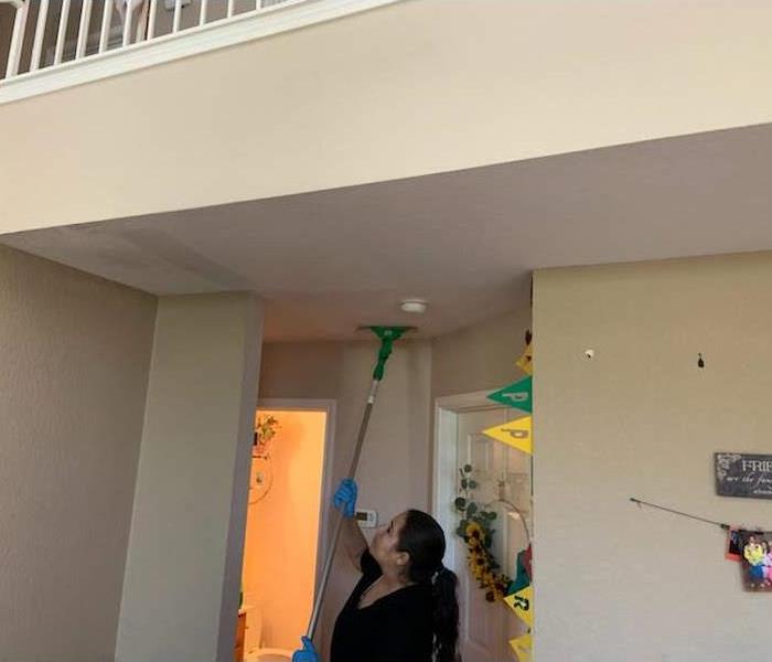 SERVPRO team member in action cleaning the ceilings.