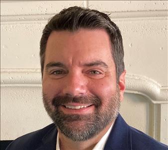 Dark haired man in sport coat and white shirt