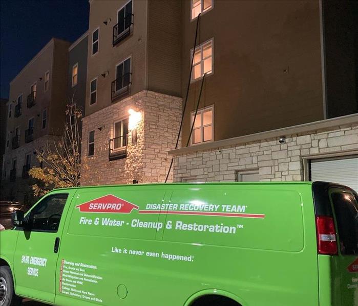 Extraction bus at night at apartment complex.