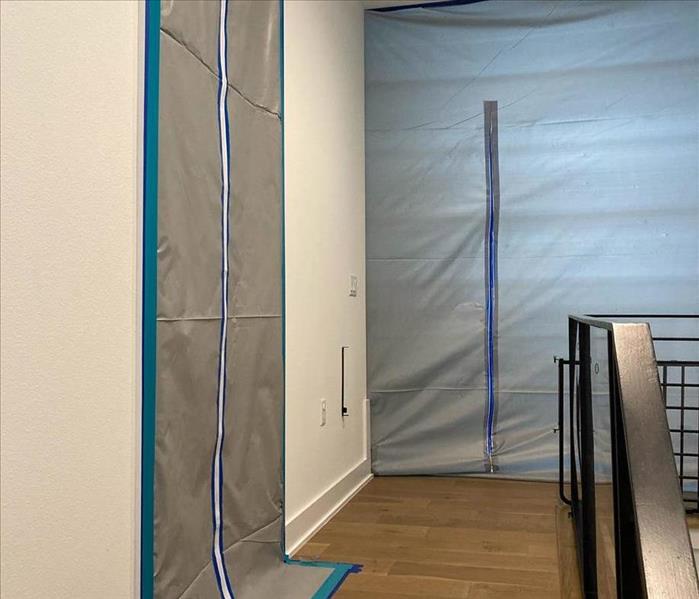 plastic and tape set up in a doorway