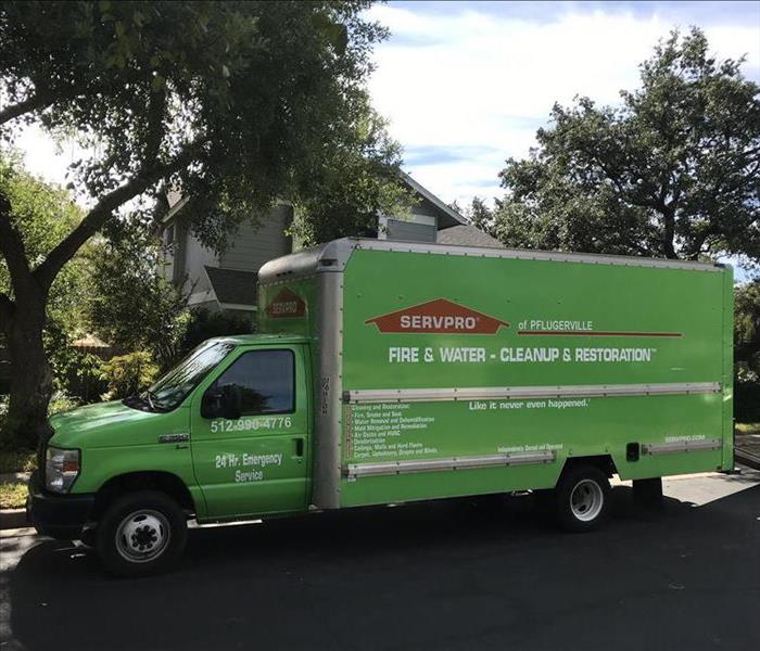 SERVPRO truck parked outside home.
