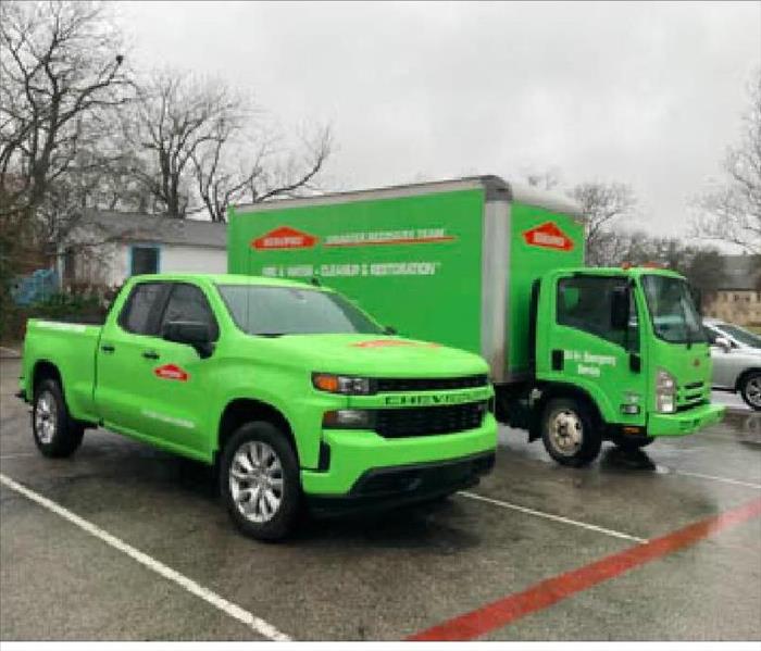 A SERVPRO truck and van parked.