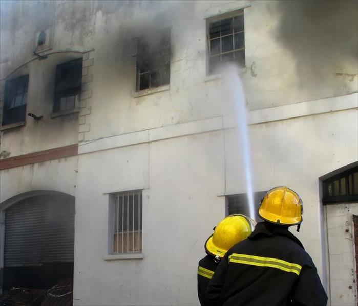 Firemen putting out fire in old building