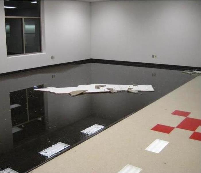 Empty room of a building with standing water. Concept commercial water damage