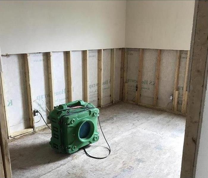 air scrubber in an empty room, flood cuts performed on drywall. Concept Mold removal