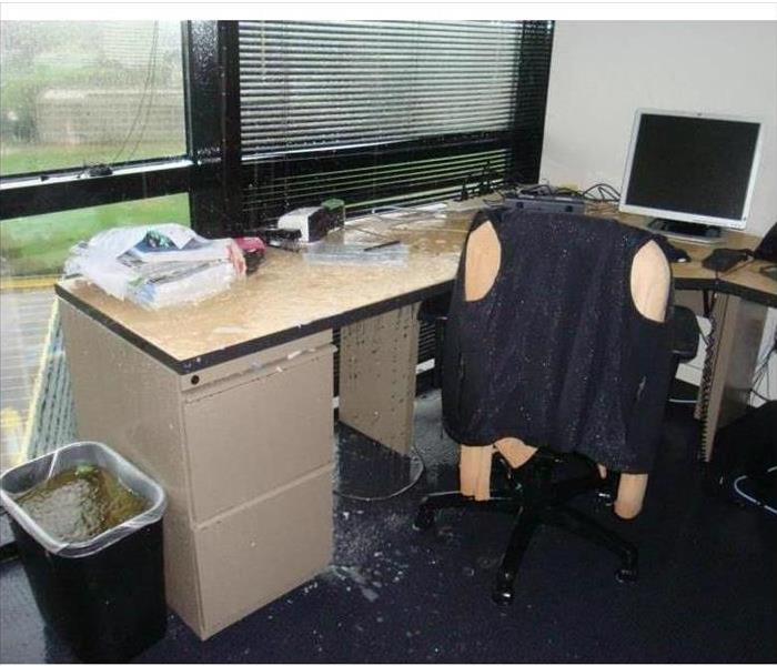 An office desk with water on top due to heavy rain